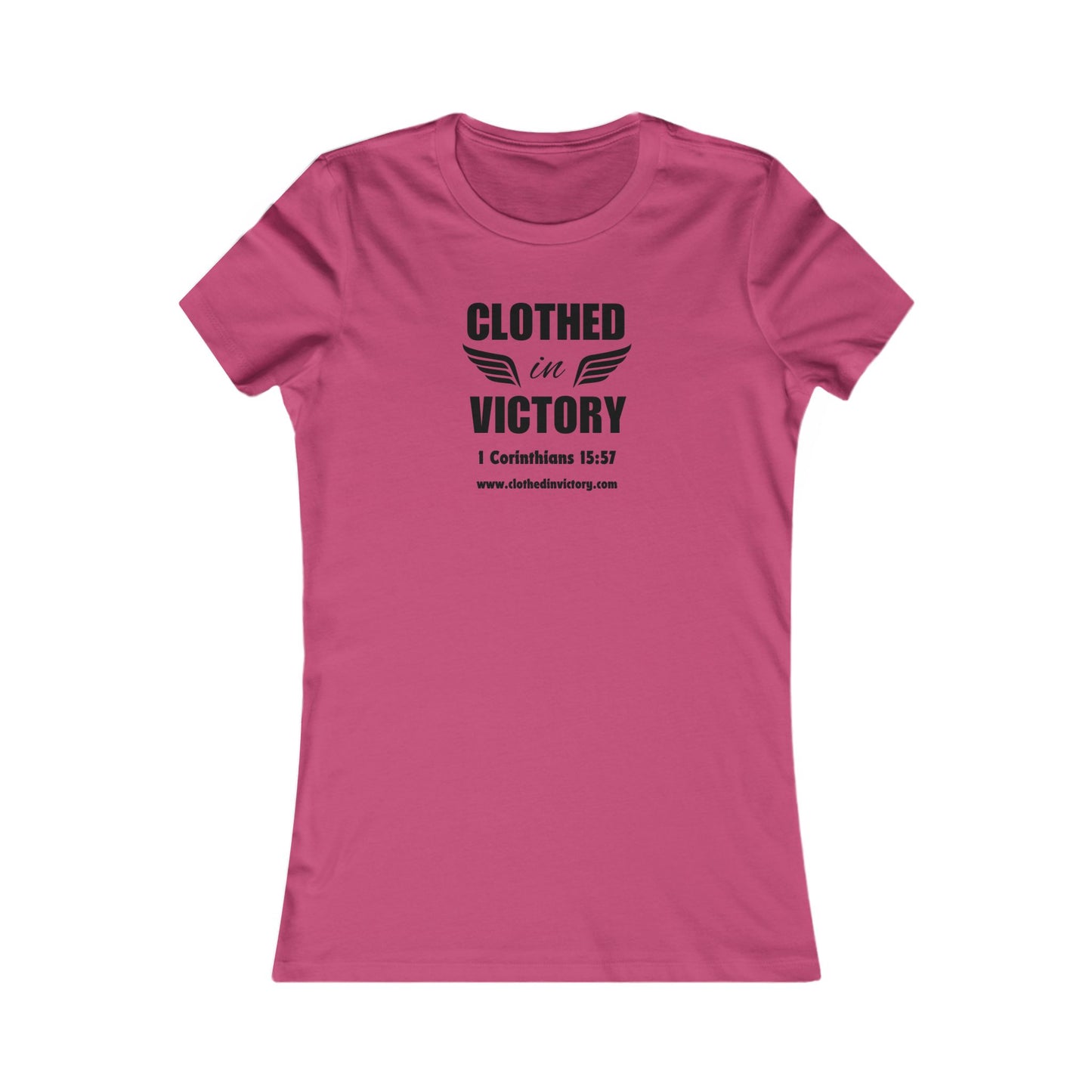 A pink t-shirt with the text "CLOTHED in VICTORY" and a pair of wings. The Bible verse 1 Corinthians 15:57 is also printed on the shirt.