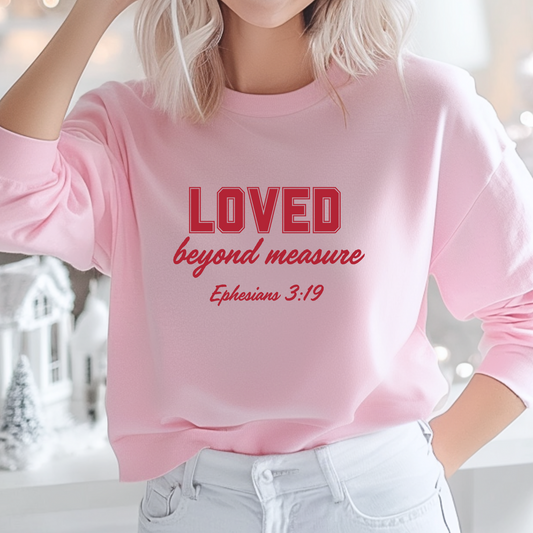 Girl wearing a pink T-shirt with "Loved beyond measure" written in red