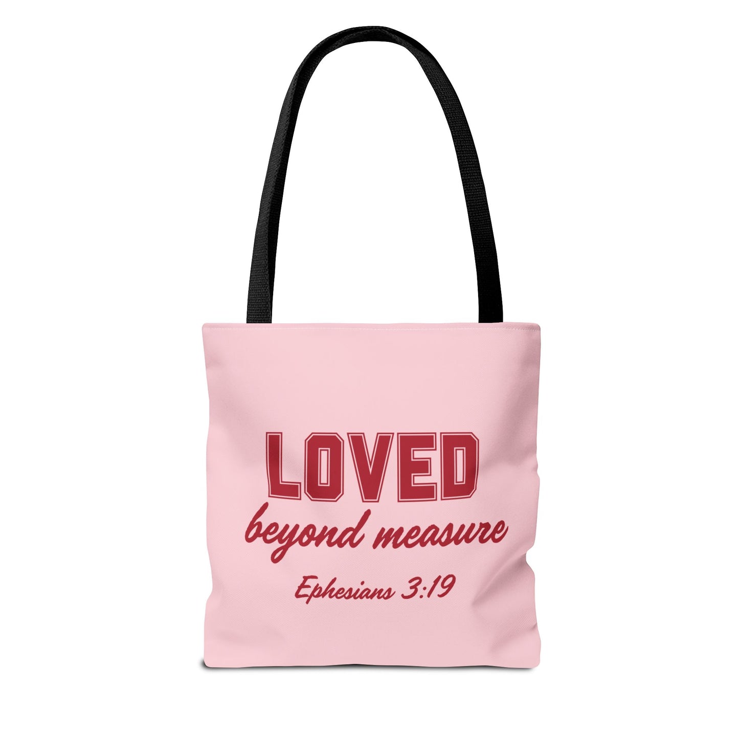 A pink bag with red text that says "Loved Beyond Measure" and black straps.